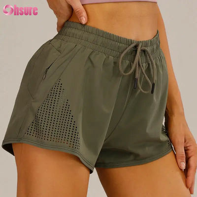 Großhandel Damen Sport Workout Shorts Atmungsaktive Laser Cut Jogging Shorts mit Warm-up Reißverschluss Seitentasche Einfarbig