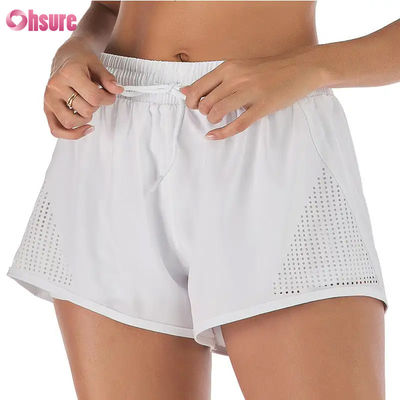Großhandel Damen Sport Workout Shorts Atmungsaktive Laser Cut Jogging Shorts mit Warm-up Reißverschluss Seitentasche Einfarbig